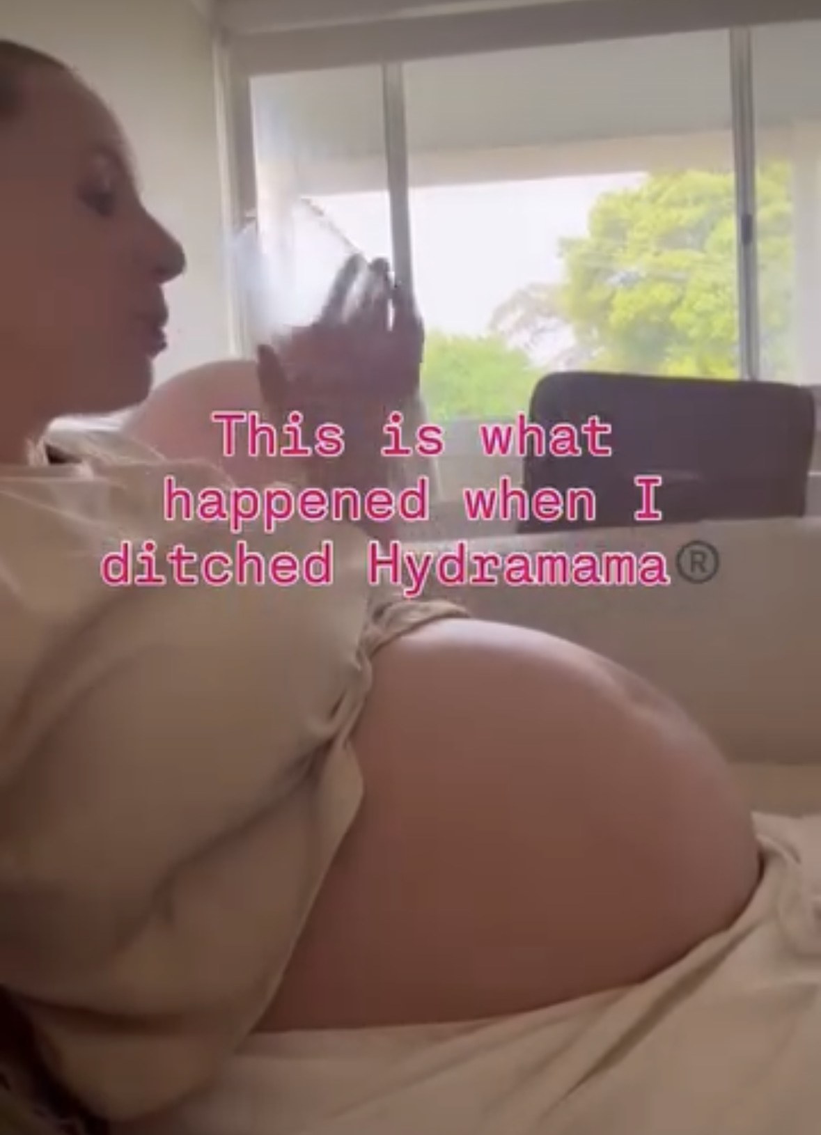 Pregnant Ash drinking water on the couch, with a caption about ditching Hydramama